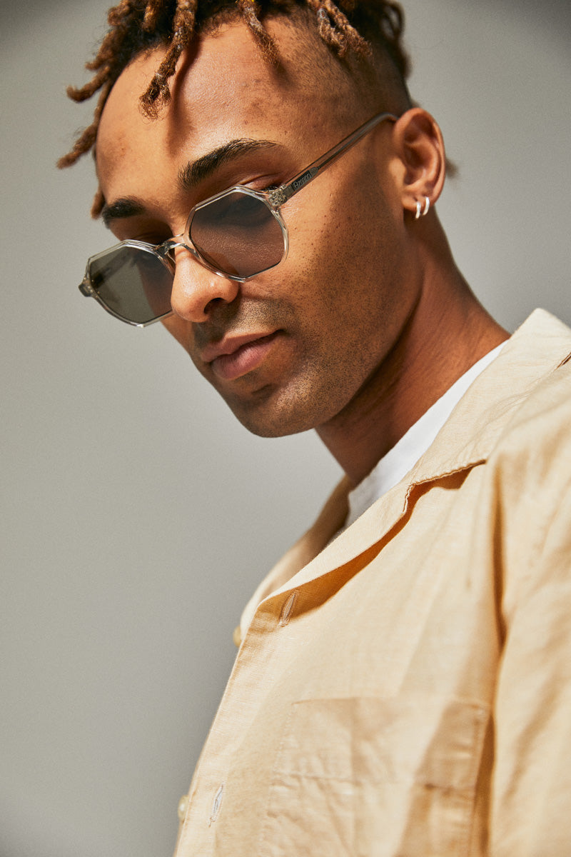 Male model wearing green prescription sunglasses from Ozeano Vision