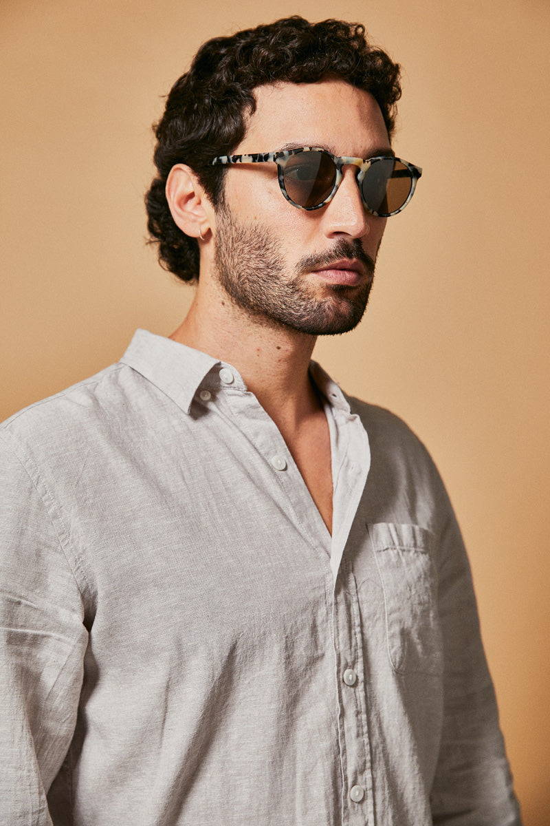 Male model wearing black and white prescription sunglasses