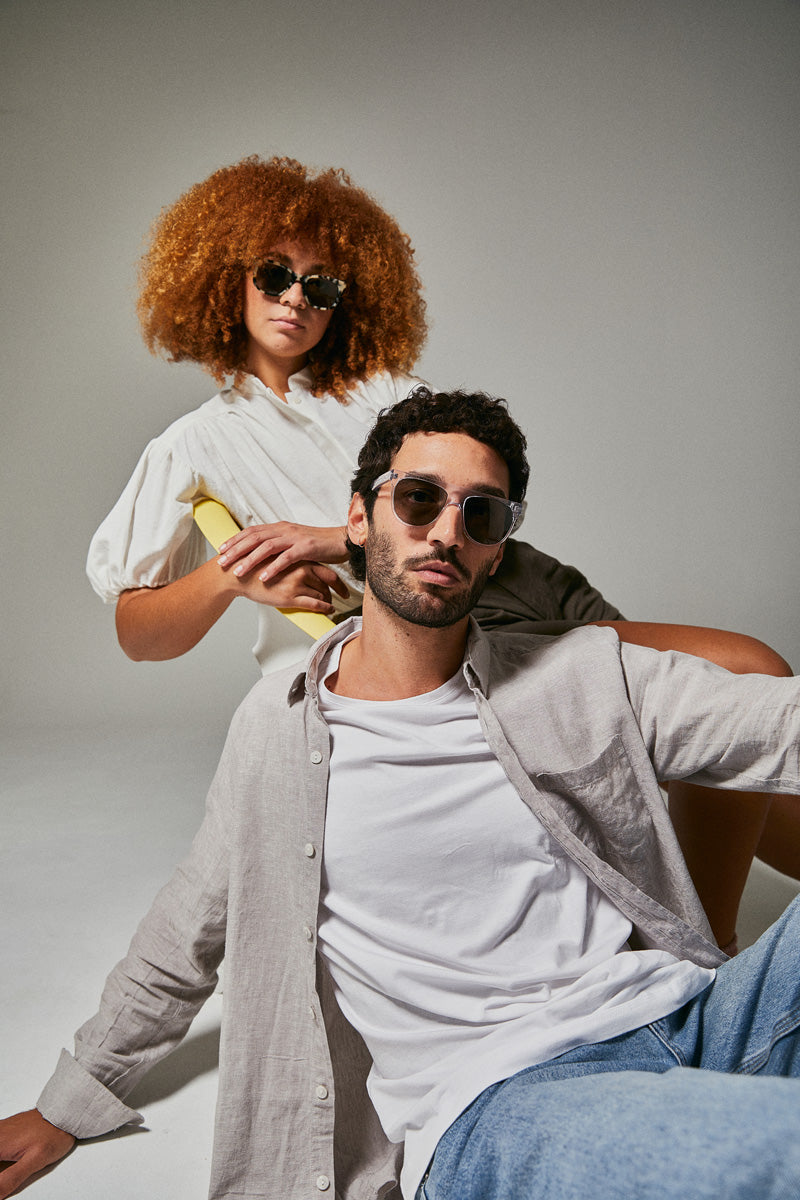 Female and male models wearing prescription sunglasses from Ozeano Vision