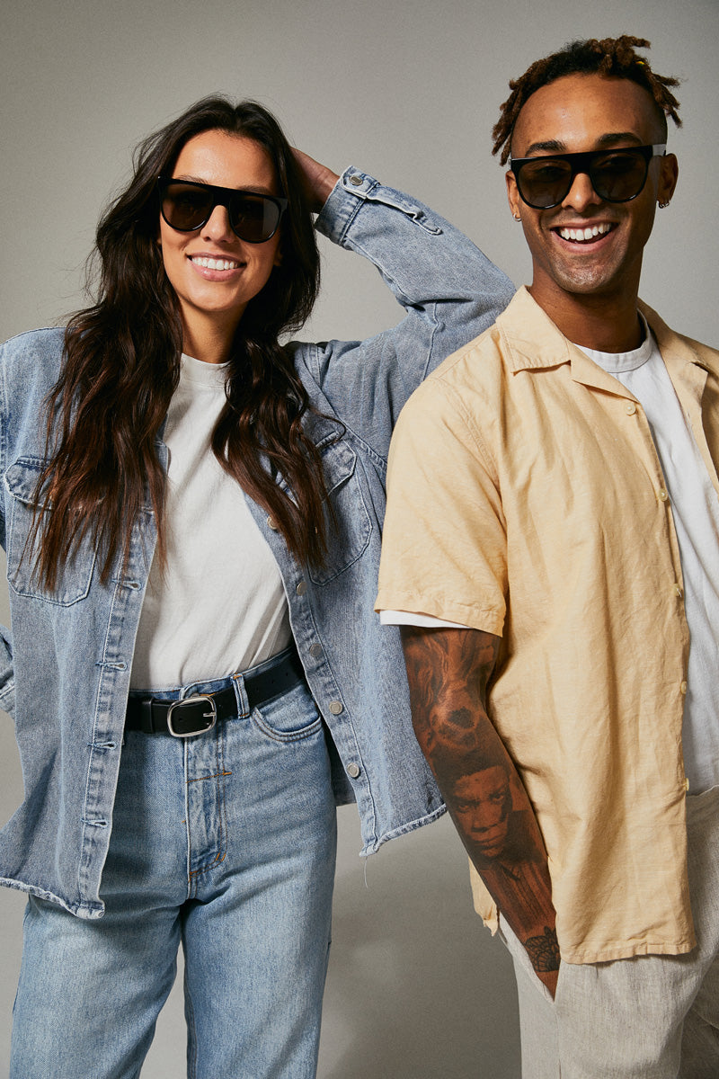 Female and male models wearing black polarised sunglasses from Ozeano Vision