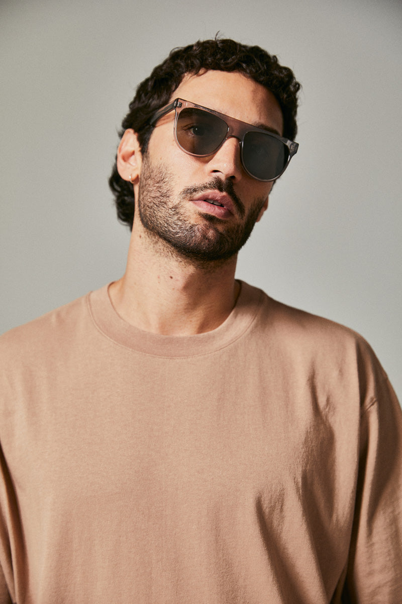 Male model wearing grey prescription sunglasses from Ozeano Vision