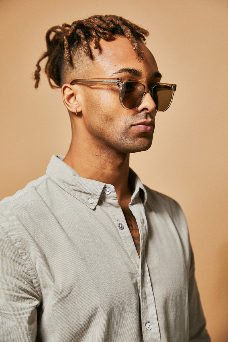 Male model wearing green polarised sunglasses from Ozeano Vision