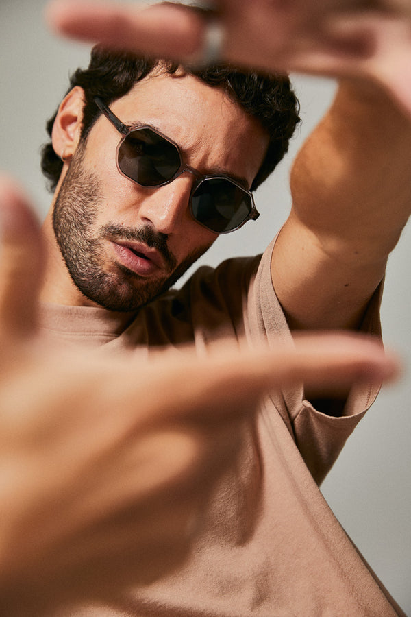 Male model wearing grey prescription sunglasses from Ozeano Vision