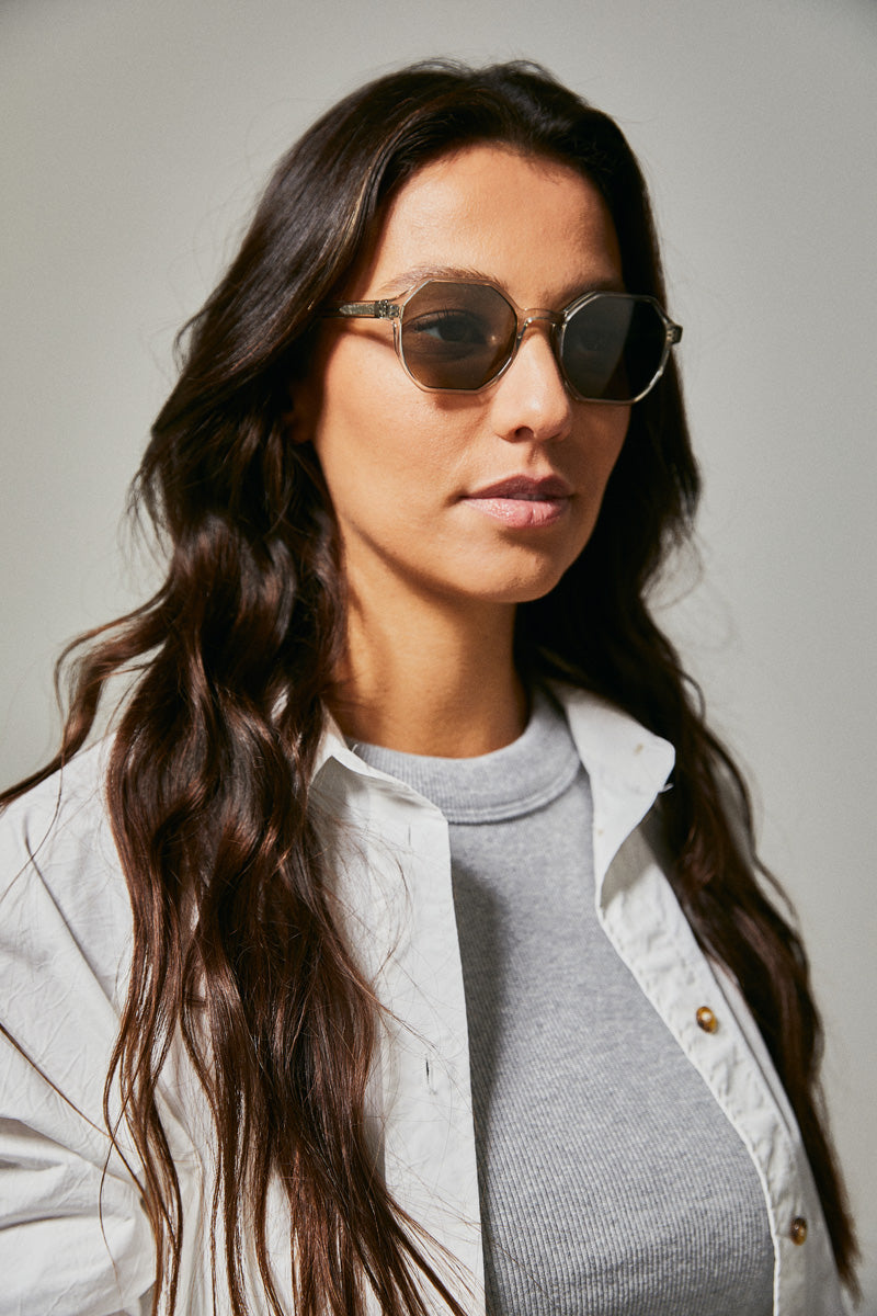 Female model wearing green prescription sunglasses from Ozeano Vision