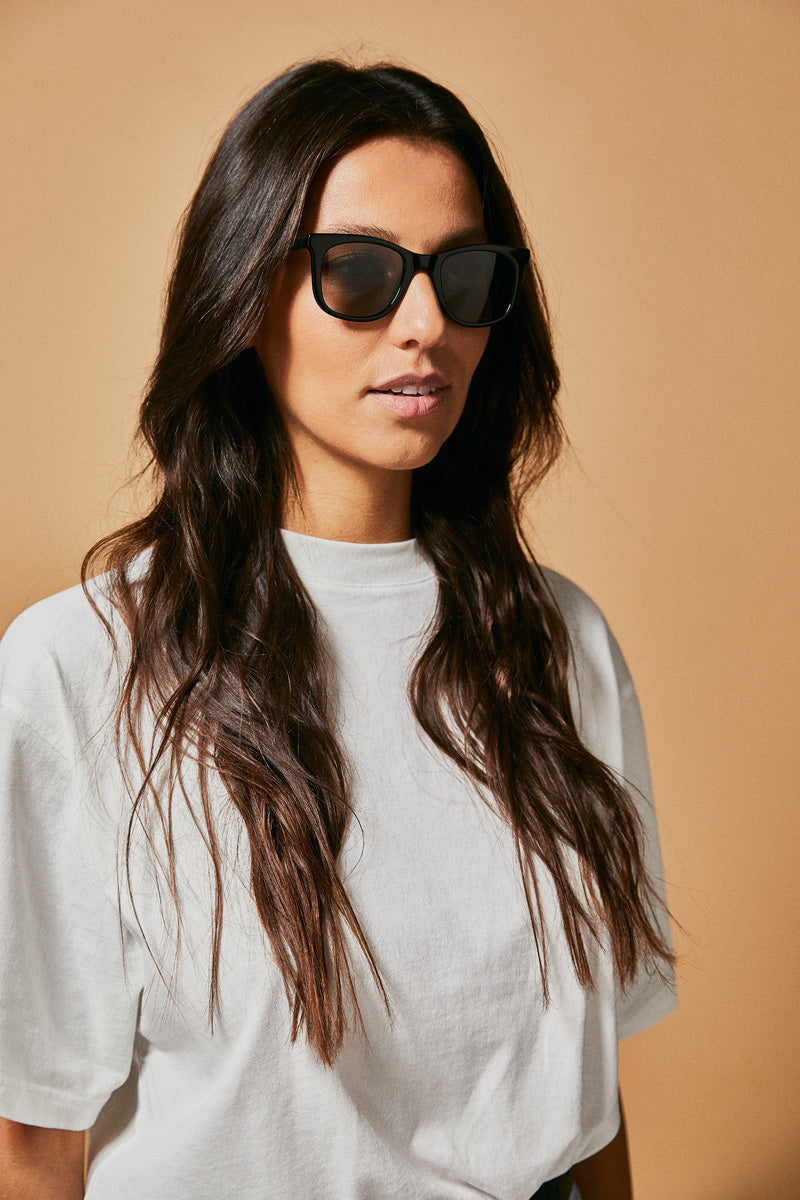 Female model wearing black polarised sunglasses from Ozeano Vision
