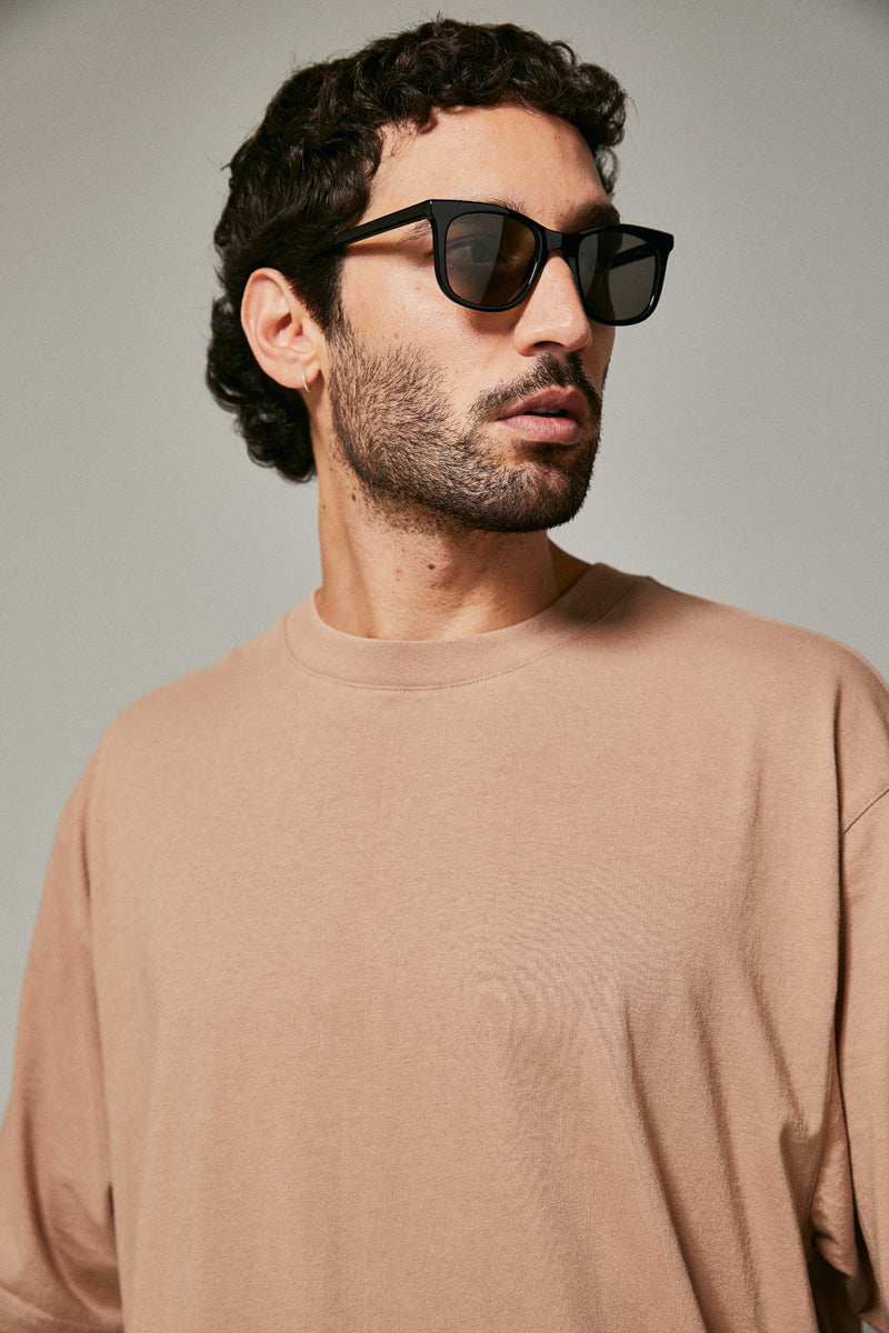 Male model wearing black prescription sunglasses from Ozeano Vision