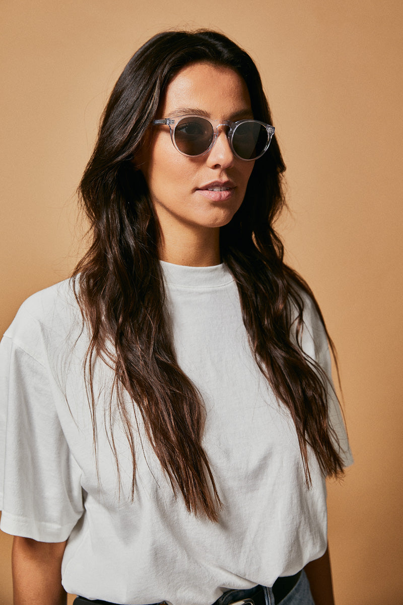 Female model wearing translucent prescription sunglasses