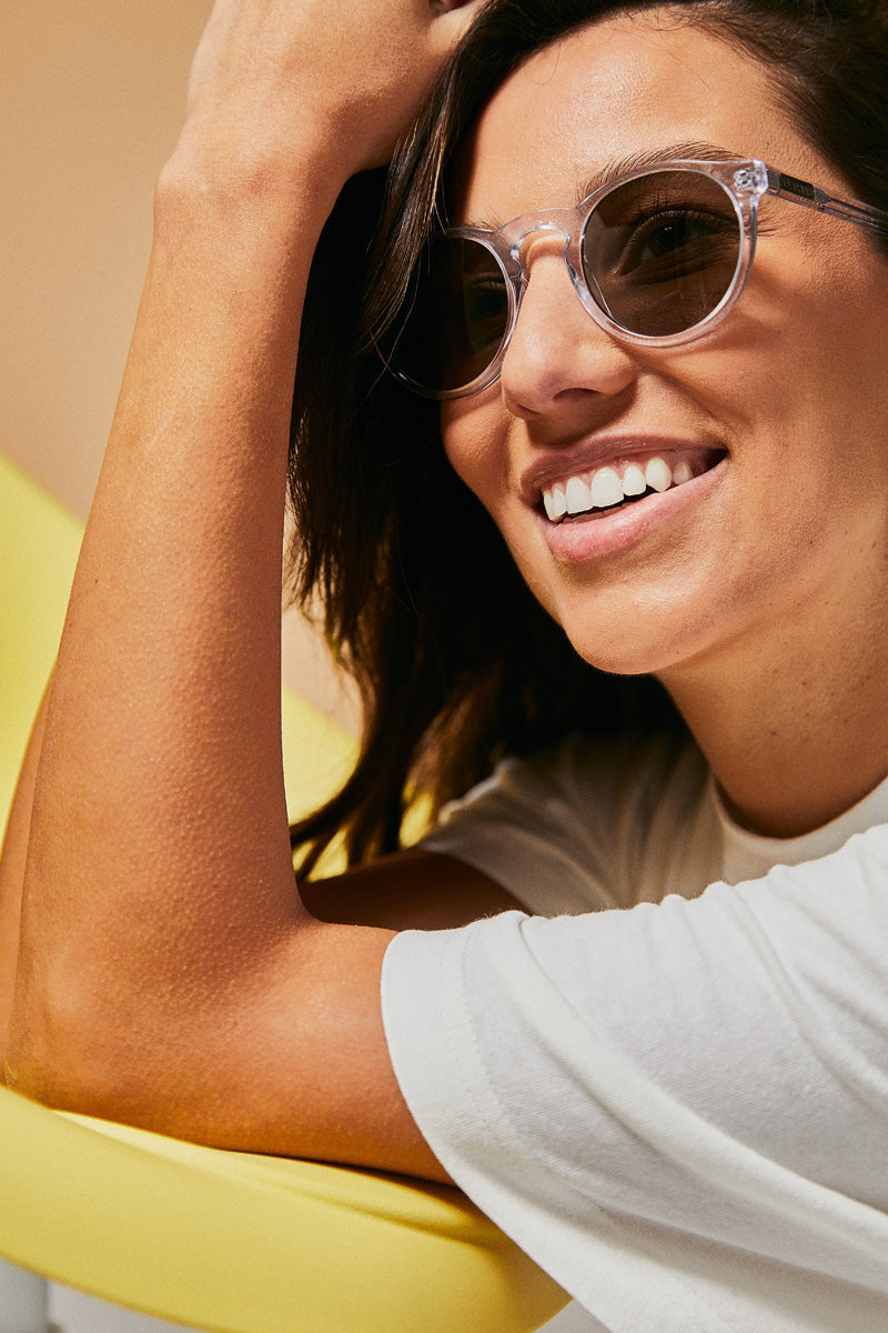 Female model wearing translucent prescription sunglasses