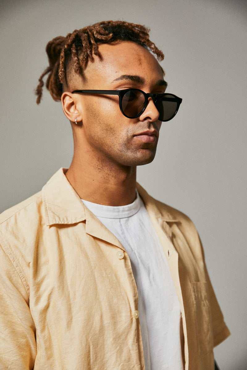 Male model wearing black prescription sunglasses
