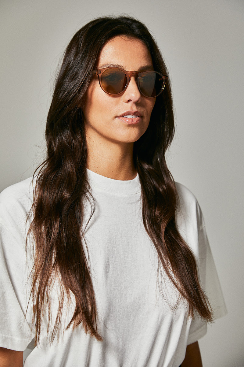 Female model wearing brown polarised sunglasses